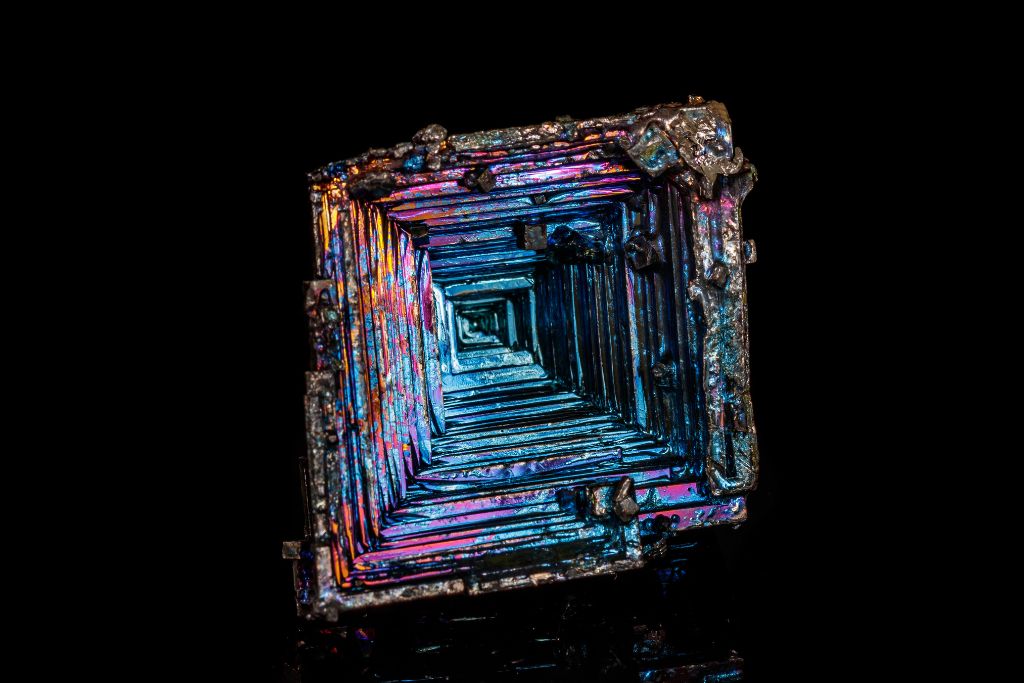 A bismuth crystal on a black background