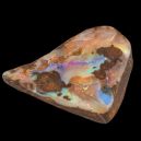 a cut of boulder opal crystal on a black background