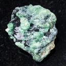 A Demantoid Garnet on a black granite