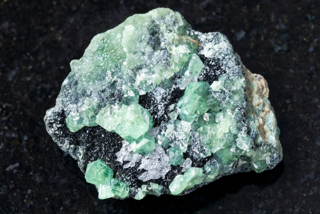 Demantoid Garnet on a black granite