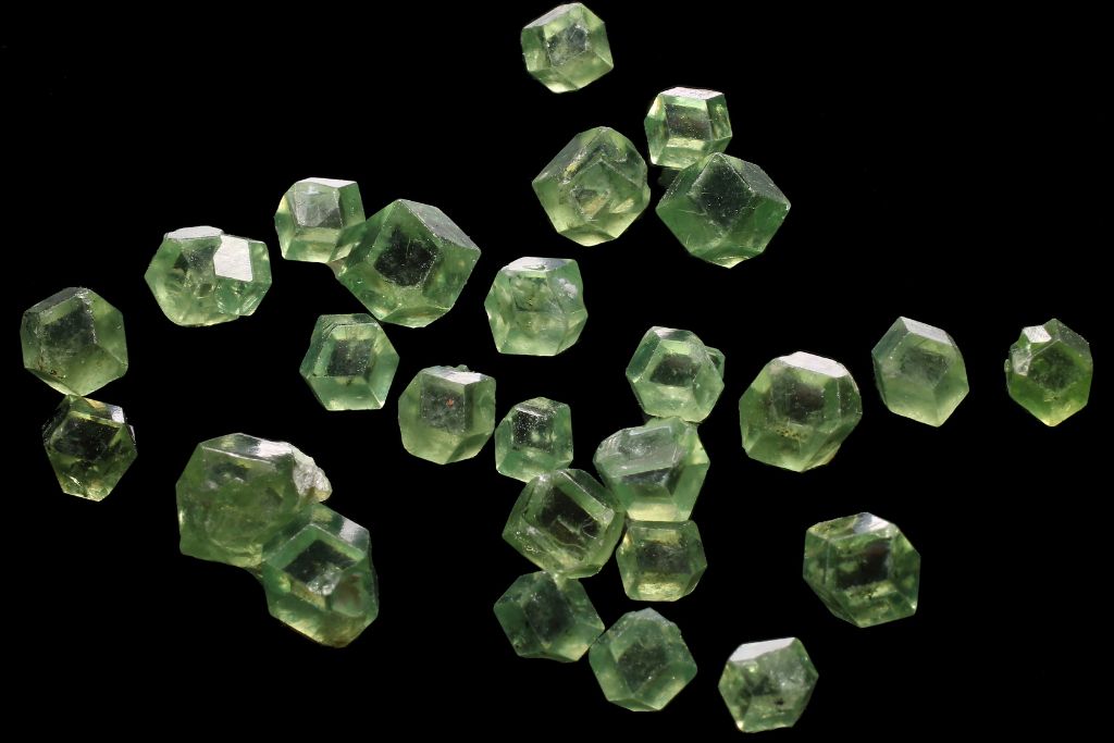 Polished Demantoid Garnet crystals on a black background