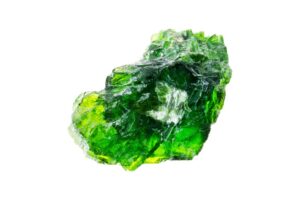 A Raw Diopside crystal on a white background