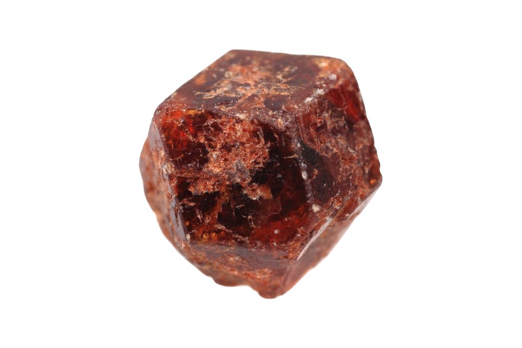 A raw garnet on a white background