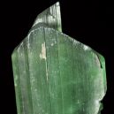 A Hiddenite crystal on a black background