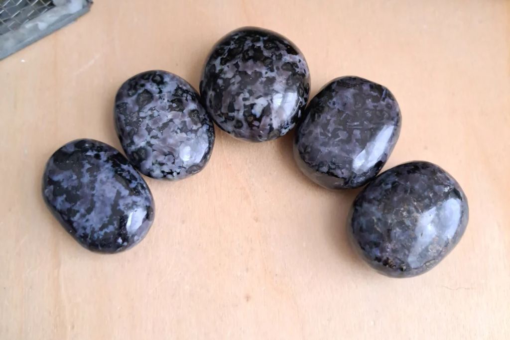 Polished Indigo Gabbro on a table. Source: Etsy | CrystalsofTheMyst