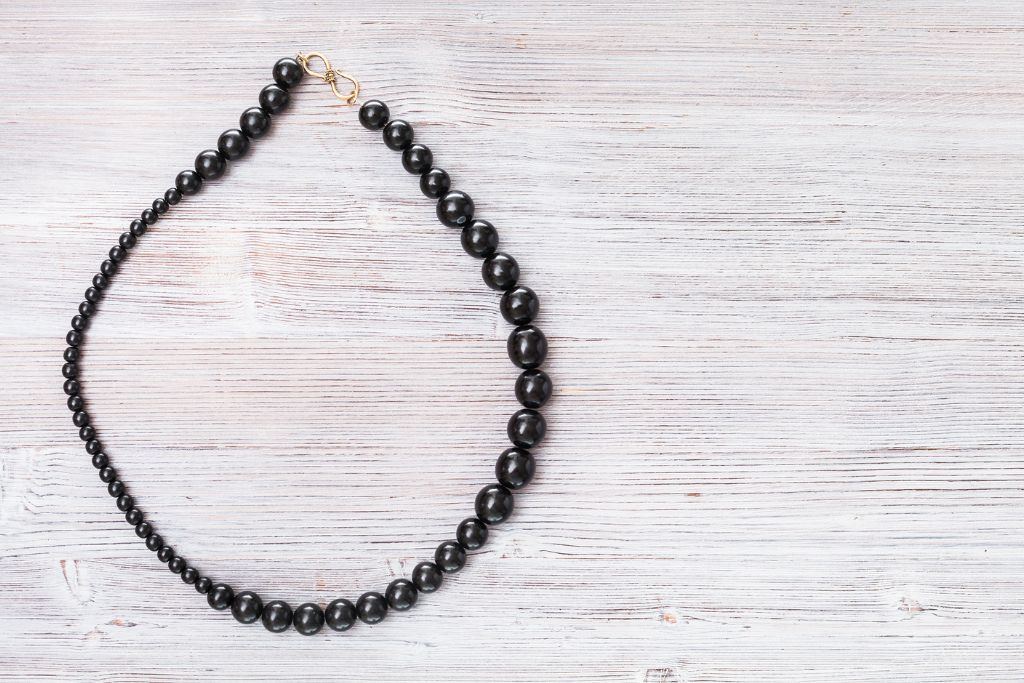 A jet necklace on a wooden table