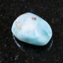 A larimar crystal on a black reflective background