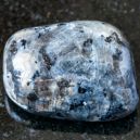 A polished Larvikite on a black granite
