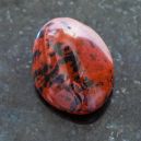 A Mahogany Obsidian Crystal on a black granite