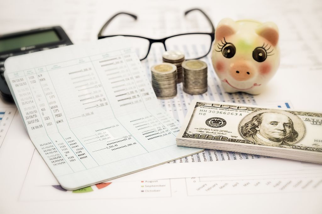 Money, coins and a passbook on top of the papers