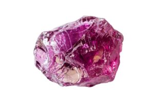 A raw Rhodolite crystal on a white background