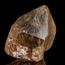 A rutilated quartz on a black reflective background