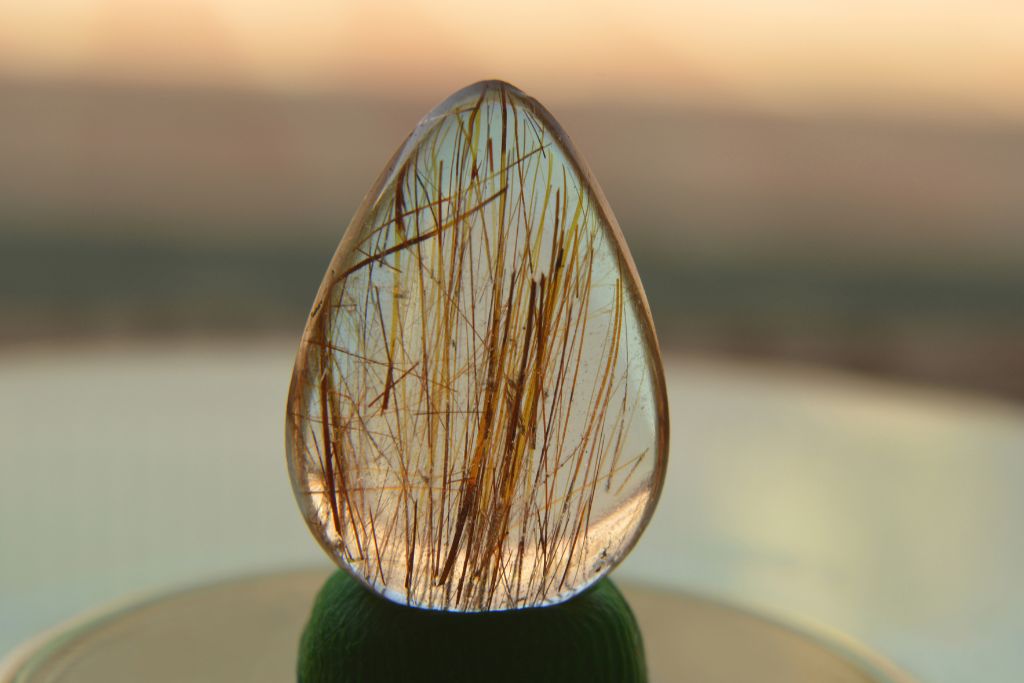 A polished Rutilated Quartz on a table