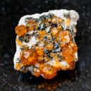 A Spessartite Garnet on a black granite