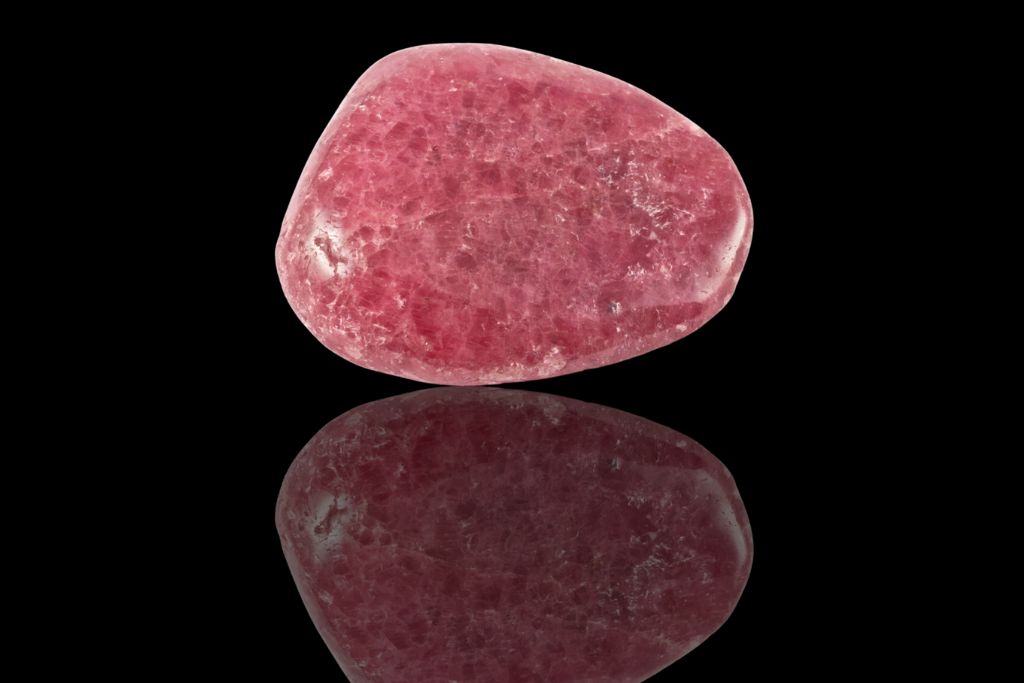 Strawberry Quartz (Cherry Quartz) on a black and reflective background