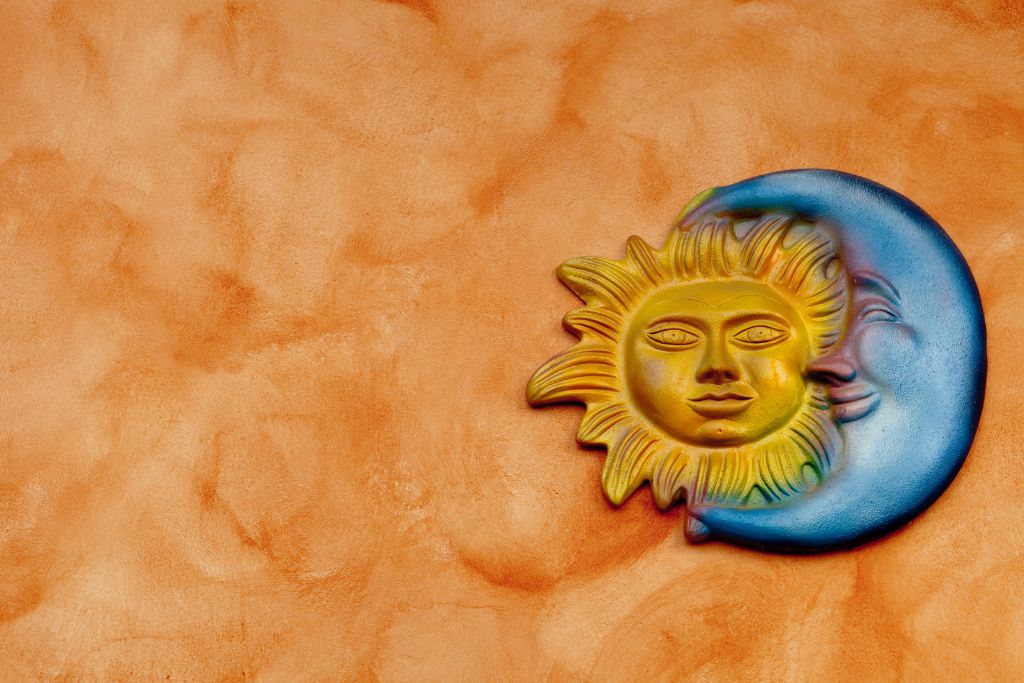 A sun and moon symbol on an orange background