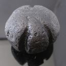 Tektite stone on a graphite table