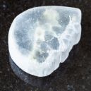 Ulexite crystal on a black granite