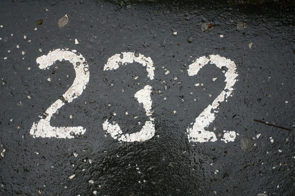 angel number 232 parking number painted in white