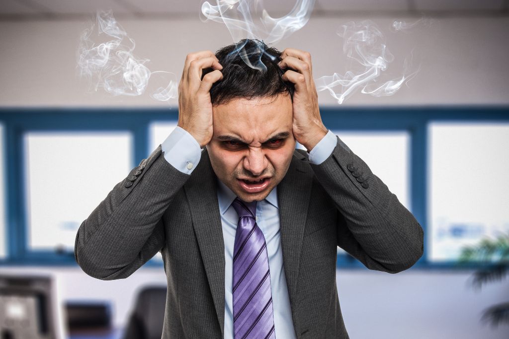 a man acting angry inside his office