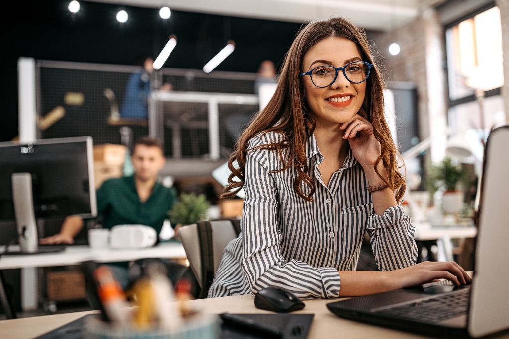 A woman is smiling in the office