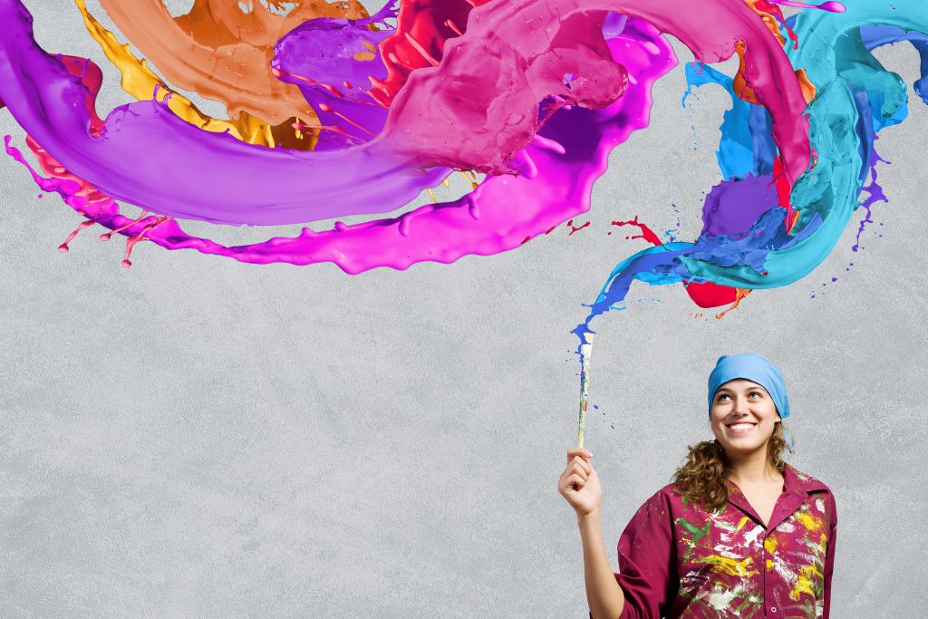 a woman expressing her creativity on a grey background