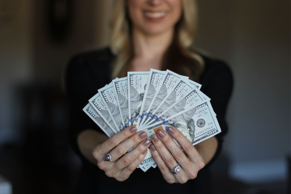 wealthy woman showing her money