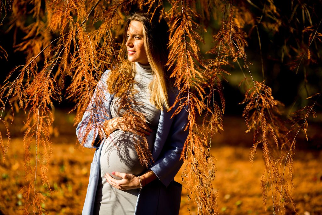 a beautiful pregnant woman doing an outdoor photoshoot