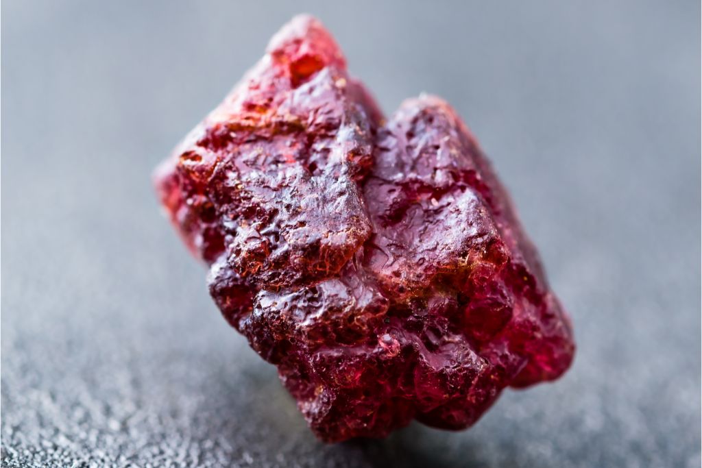 A raw spinel crystal on a dark background