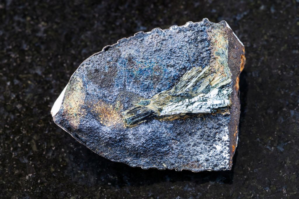 vivianite on a black granite