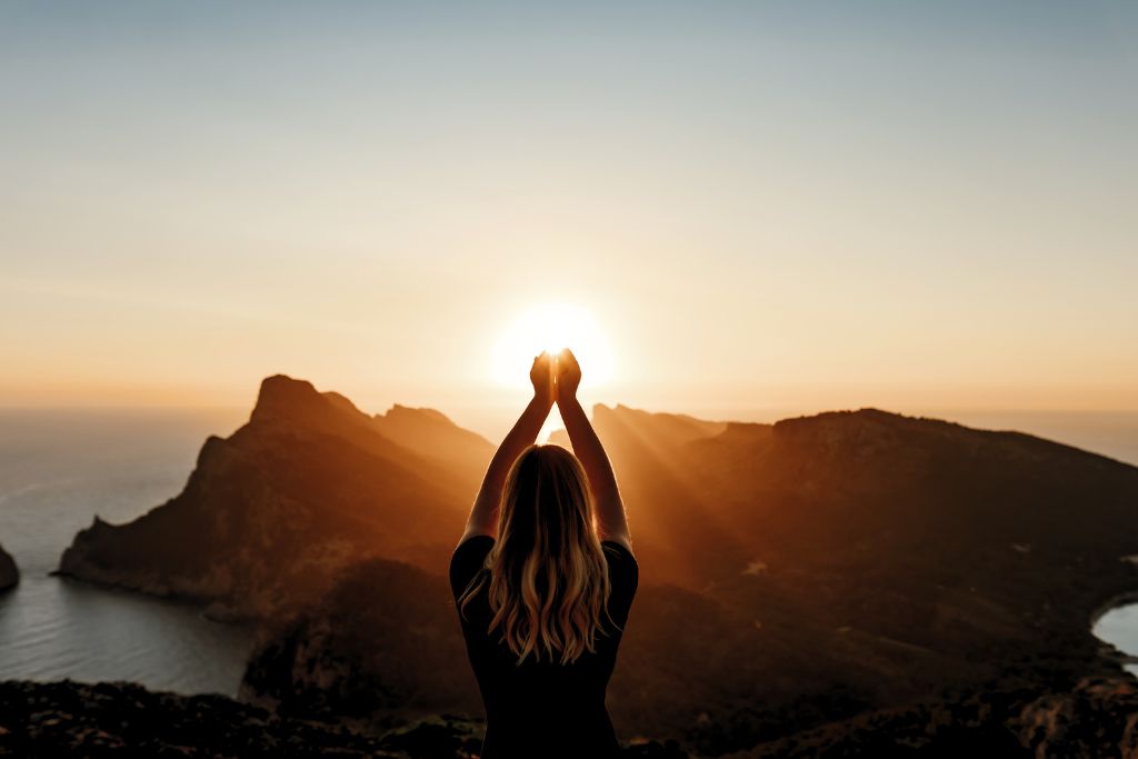 woman doing meditation and affirmation in an outdoor environment