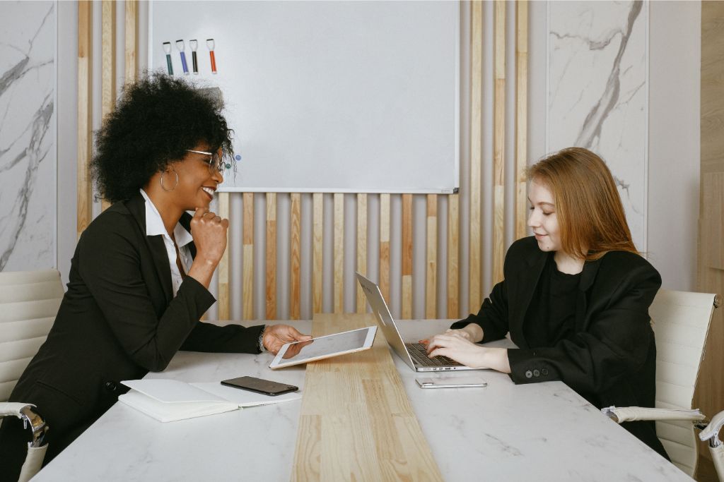 woman talking to her boss at office