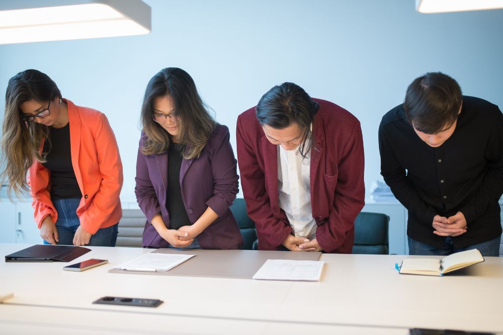 A group of people bowing down