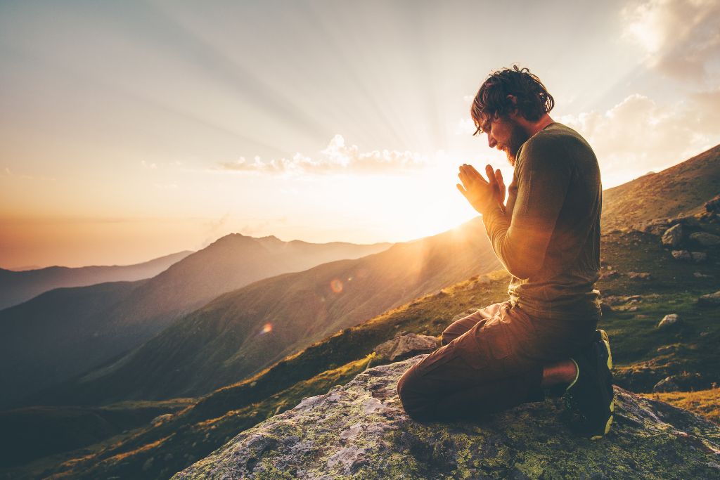 A man is praying on the Mountains