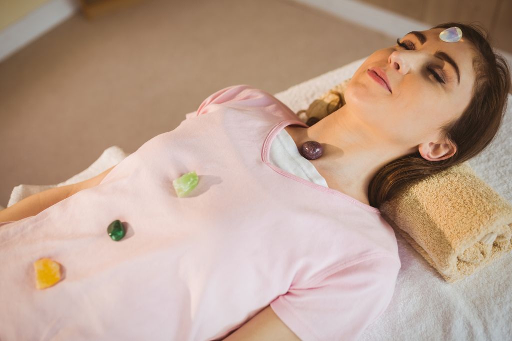 A woman with crystals over her body 