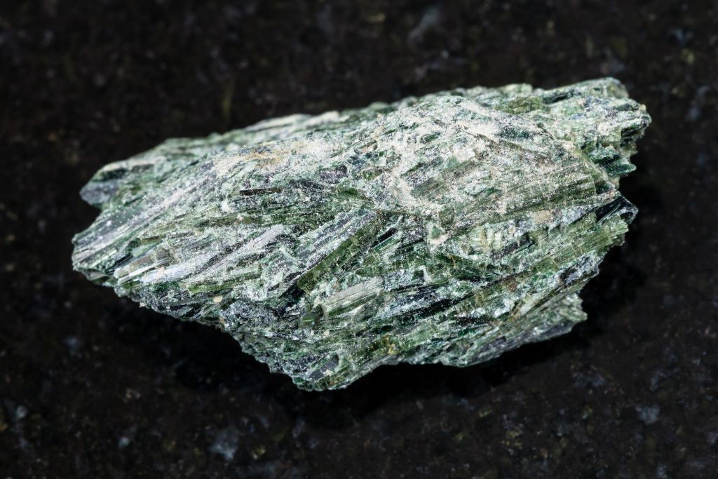 Actinolite on a black granite