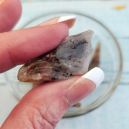 A woman holding a Cacoxenite crystal. Source: Etsy | crystalgemstoneshop