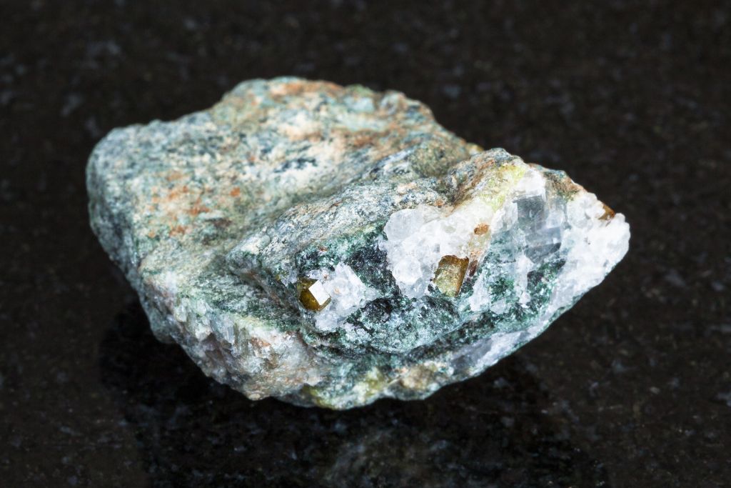 Chrysoberyl crystal on a black granite