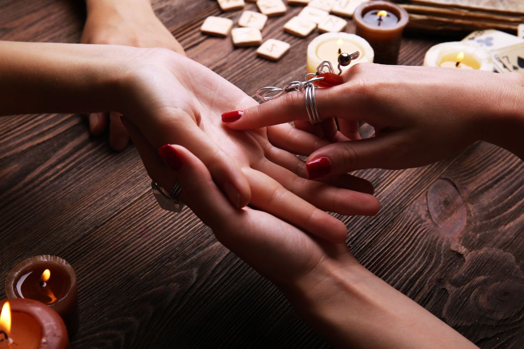 a fortune teller reading someone's palm