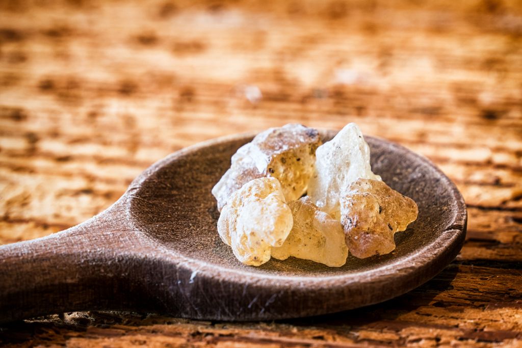 Copal crystals on a wooden spoon