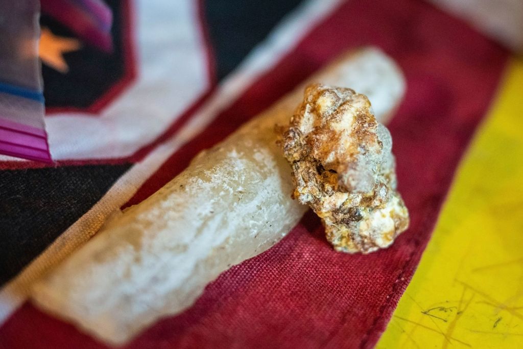 A white and gold copal on a piece of cloth