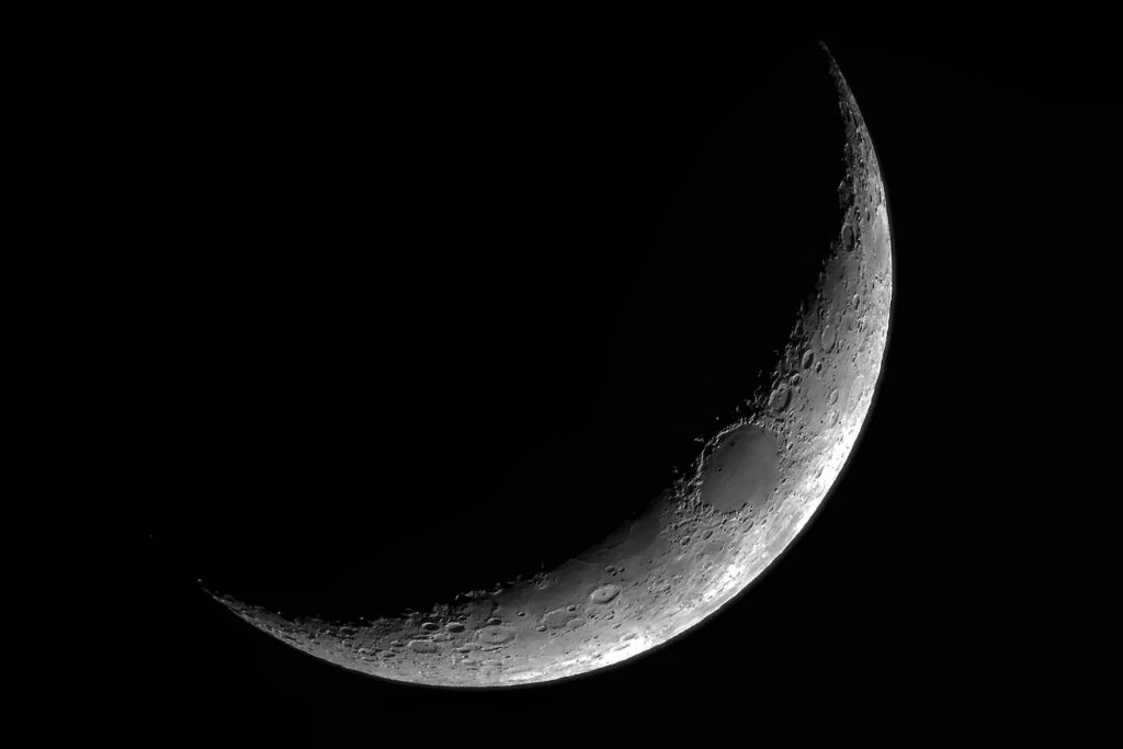 A Crescent moon turning into a Dark moon on the sky