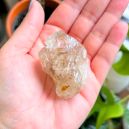 woman holding a chunk of Elestial Quartz. Image Source: Etsy.com | Jennifer-BotanyCrystals