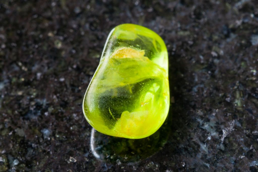 Forsterite on a black granite table