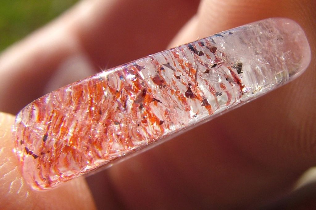 Elongated shaped Harlequin Quartz on finger tips