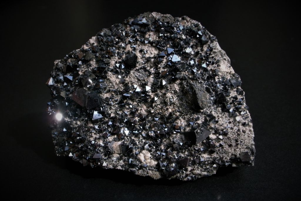 A lodestone crystal on a dark background