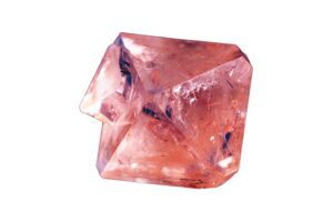 A raw Spinel Crystal on a white background