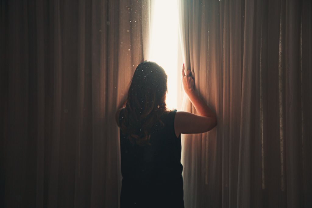 woman looking out the window