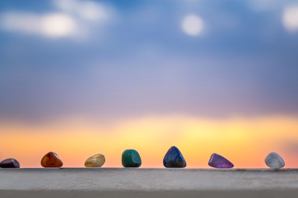 Chakra crystals were organized and lined up against a sunset background.