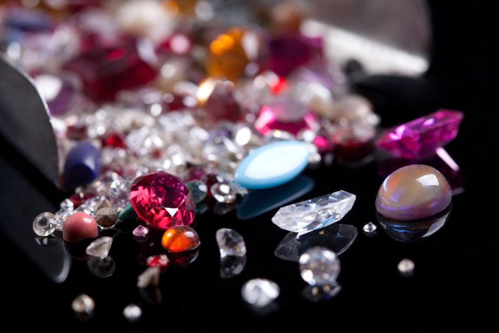 different types of crystals scattered on a black table